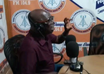 Representative Robert Womba speaking during radio interview in Bong County