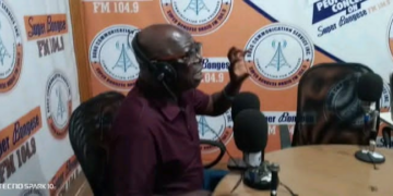 Representative Robert Womba speaking during radio interview in Bong County