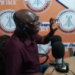 Representative Robert Womba speaking during radio interview in Bong County