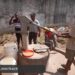 Workers repair a hand pump at Gbarnga Central Prison in Bong County