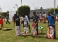 Children participate in sack races and learning games during KEEP Liberia’s PlayFest, a literacy-focused family event in Monrovia.