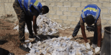 Youth volunteers sort collected plastic waste for recycling in Gbarnga, Bong County.