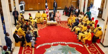lawmakers assembled at the Executive Mansion to thank President Boakai for the bringing in the earth-moving equipment. They were all dressed in yellow