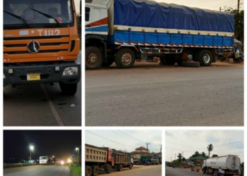 Trucks improperly parked along roadside in Gbarnga creating traffic hazard