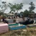 Families cleaning and decorating graves during Decoration Day in Liberia.