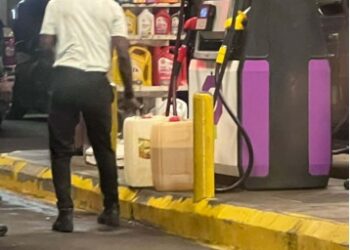 Customers queue at a gas station in Liberia amid concerns about fuel hoarding and price increases.