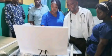 Health officials and medical staff inspect a newly donated colposcope machine at C.B. Dunbar Comprehensive Hospital in Gbarnga, Bong County.