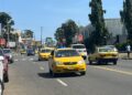 Yellow taxis operating on a busy street in Monrovia amid rising transport fares.