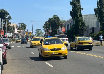 Yellow taxis operating on a busy street in Monrovia amid rising transport fares.