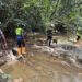 EPA and security personnel inspect Marvoe Creek following contamination linked to mining operations.
