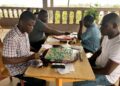 Scrabble players competing during a board game session in Liberia