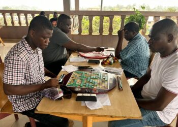 Scrabble players competing during a board game session in Liberia