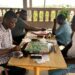 Scrabble players competing during a board game session in Liberia