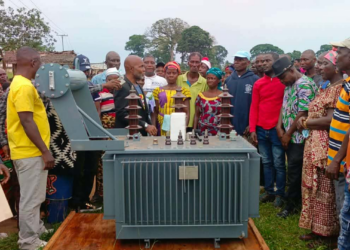 Residents gather around newly donated electricity transformer in Barriken Township, Maryland County.