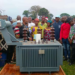 Residents gather around newly donated electricity transformer in Barriken Township, Maryland County.