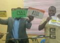 Officials display new Liberian vehicle license plates during the transition of licensing services to Liberia Traffic Management Inc.