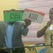 Officials display new Liberian vehicle license plates during the transition of licensing services to Liberia Traffic Management Inc.