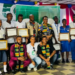 Liberian students holding certificates at ECOWAS 50th anniversary quiz competition in Kakata