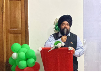 Upjit Singh Sachdeva speaking at podium during rubber industry event in Liberia