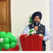 Upjit Singh Sachdeva speaking at podium during rubber industry event in Liberia