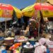 Market women selling goods inside a busy market hall in Monrovia, Liberia.