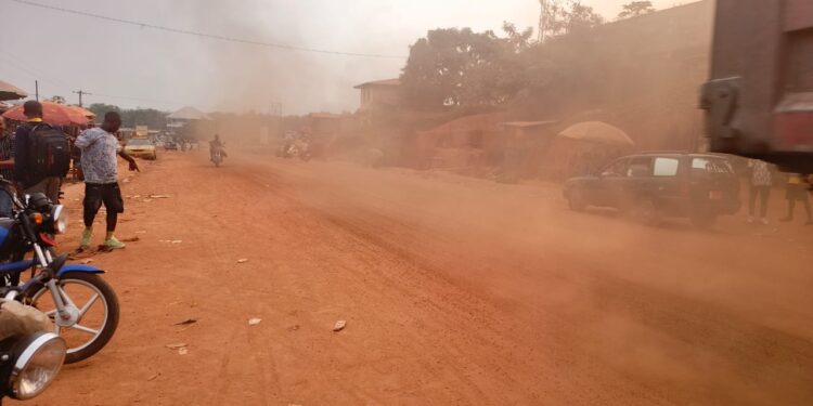 Dust rising from an unfinished road at Lofa Parking commercial area in Bong County, Liberia.
