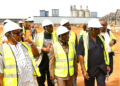 Liberian lawmakers and cabinet officials tour the new destination inspection facility under construction at the Freeport of Monrovia.