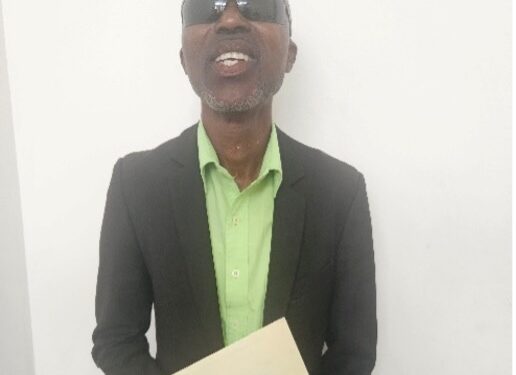 visually impaired man holding an envelope