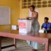 Voter casting ballot during Liberia election amid ID claim fact check