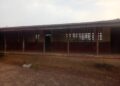 Empty classroom at Kayata Public School where students lack chairs and sit on floors in Bong County