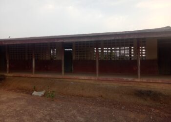 Empty classroom at Kayata Public School where students lack chairs and sit on floors in Bong County