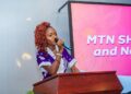 Goodness Sart speaking at an event as a rising communications professional and event host in Liberia