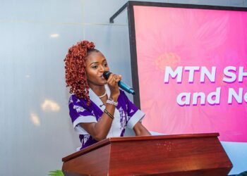Goodness Sart speaking at an event as a rising communications professional and event host in Liberia