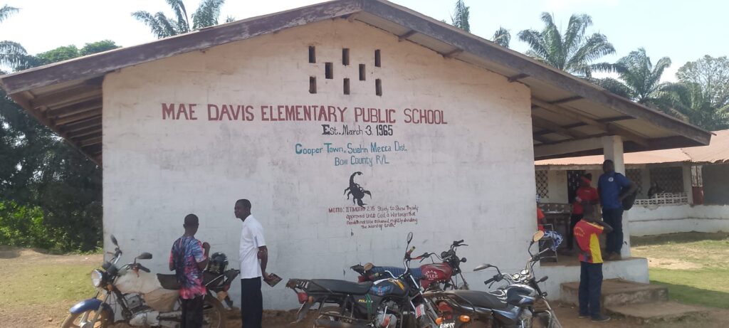 Mae Davis Public Elementary School in Bomi County where students share chairs and sit on floors due to poor conditions