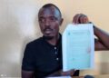 Labour official displays document amid controversy over foreign worker levy and alleged fund diversion in Liberia
