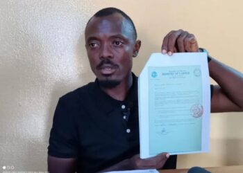Labour official displays document amid controversy over foreign worker levy and alleged fund diversion in Liberia
