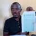 Labour official displays document amid controversy over foreign worker levy and alleged fund diversion in Liberia