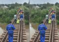 Rail workers walking along track in Caldwell Liberia