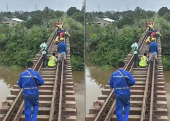 Rail workers walking along track in Caldwell Liberia
