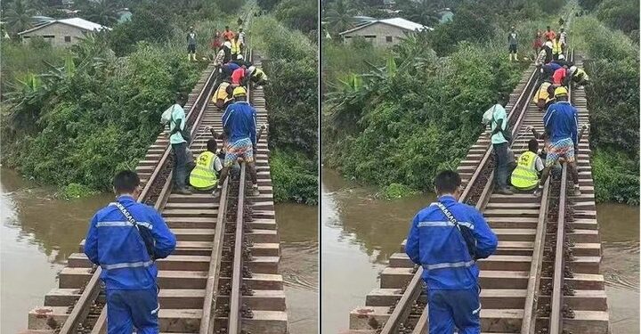 Rail workers walking along track in Caldwell Liberia