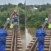 Rail workers walking along track in Caldwell Liberia