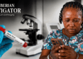 A Liberian woman checks her phone amid public concern over a false Ebola alert circulating on social media.