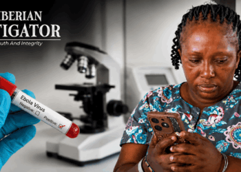 A Liberian woman checks her phone amid public concern over a false Ebola alert circulating on social media.