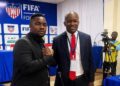 Cassell Kuoh standing with LFA President Mustapha Raji during a football event in Liberia