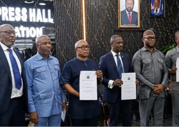 Liberian officials display signed partnership documents for a new vehicle insurance credit program for civil servants in Monrovia