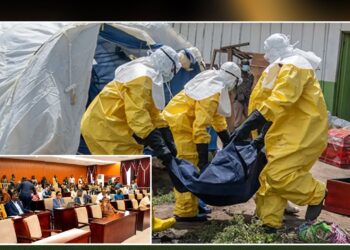 Health workers in protective suits handle an Ebola victim as Liberia lawmakers raise concerns over renewed Ebola threats from DR Congo.