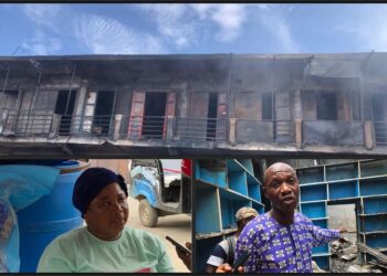 Charred shops and traders surveying damage after Red Light Market fire in Paynesville, Liberia