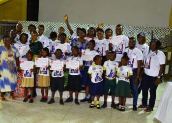 Students and teachers display certificates at New Joy Liberia literacy fair in Paynesville