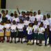 Students and teachers display certificates at New Joy Liberia literacy fair in Paynesville