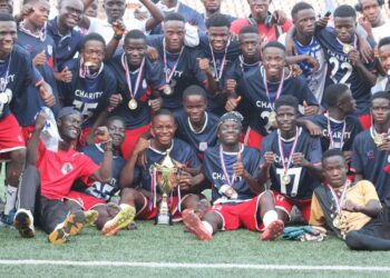 Charity High School players celebrate with trophies after winning double titles in Paynesville
